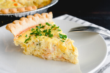 Shrimp Quiche on a White Plate: A slice of shrimp quiche on a small plate 