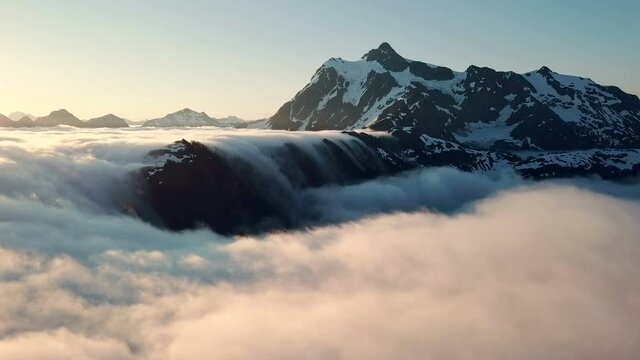 Aerial Time lapse of Heavenly Rolling Fog Around Snowy Mountains during Sunrise in Northern Washington State
