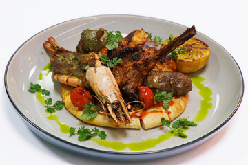 arabic style grilled seafood and meat mix platter with prawns, lamb, beef, chicken on flat bread, ramadan special