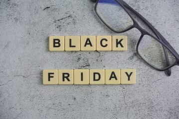Black Friday is a colloquial term for the Friday following Thanksgiving in the United States, block on ceramic background.