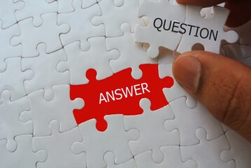 hand insert puzzle with work answer and question 