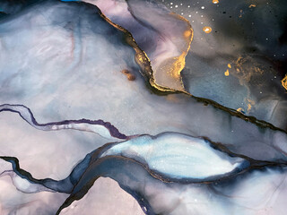 Abstract purple art with gold — violet and blue background with beautiful smudges and stains made with alcohol ink and golden pigment. Lilac fluid art texture resembles watercolor or aquarelle.