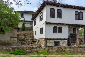 Fototapeta na wymiar Typical street and old houses at historical village of Bozhentsi, Bulgaria