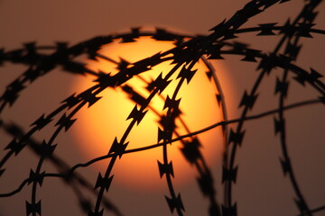sunset in the barbed wire