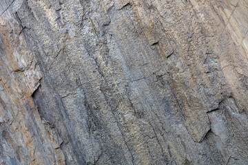 background and texture of rock layers and cracks in sedimentary rocks on a rock in Karelia