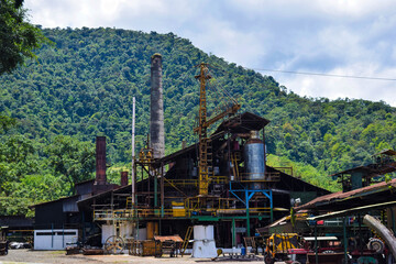 An abandoned factory in one of the cantons of Costa Rica with the glistening forest behind it