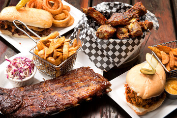 Barbecue restaurant food selection.  Barbecued pork ribs, beef ribs, pulled pork sandwich, and beef...