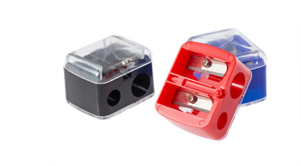 Space for text. Three pencil sharpeners of black, red and blue colors. White background