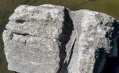 large grey boulder in river