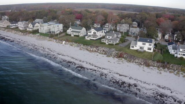 Aerial Moving Forward Over A Coastal New England Neighborhood With Gentle Waves, A Rocky Shoreline, And Rows Of Stately Homes - Kennebunkport, Maine
