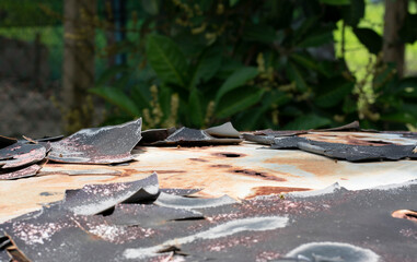 Close-up of peeled body paint from top of an old car. Selective focus points. Blurred background