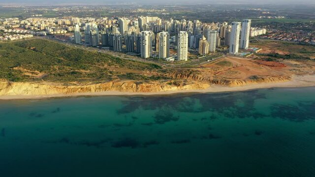 Aerial Forward Shot Of Buildings Structures Co Landscape By Sea, Drone Flying Over Beach In City - Netanya, Israel