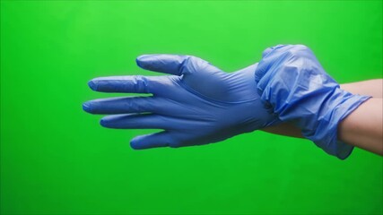 Close-up of doctor hands wearing blue medical gloves for safety protection green background, vaccine against coronavirus, vaccination against covid-19, laboratory research concept. 