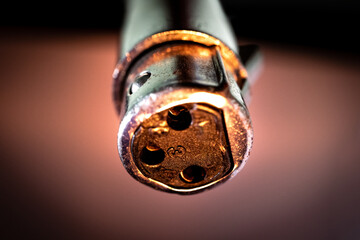 Macro Closeup of Worn Out Three Pin XLR Connector In Front of White Background