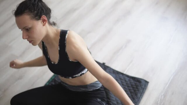 Woman doing physical exercise and stretching spine on a mat, exercise, yoga and relaxation concept