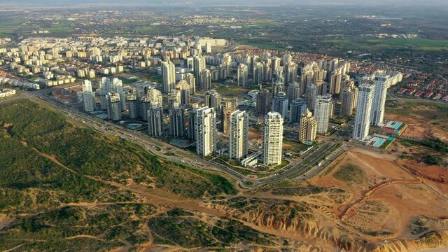 Aerial Backward Shot Of Buildings Structures Co Landscape By Sea, Drone Flying Over Beach In City - Netanya, Israel