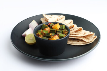 Indian style Masala Sabji OR Sabzi of fried Bhindi OR  Aloo bhindi Okra also known as Ladyfinger, Served with indian roti ,chapati or Indian Flat bread