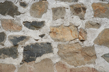 Cement wall texture with large stones. Gray and brown color. Background for design