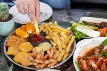 Snacks in a tray placed on the dining table Together with other foods