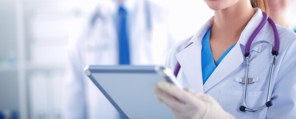 Woman doctor standing with folder at hospital