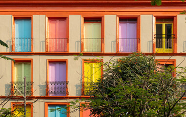 Fototapeta na wymiar Facade of an apartment building with colored doors, door concept