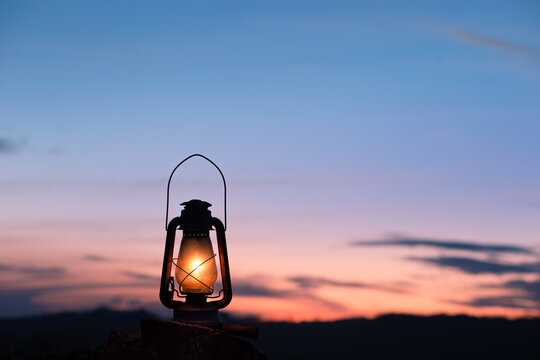 Kerosene lamp lit with a beautiful sky after sunset. Rustic lantern lit.