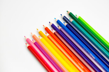 Coloured Pencils on White Paper Background