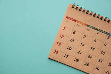 Close up of calendar on green background, planning for business meeting or travel planning concept