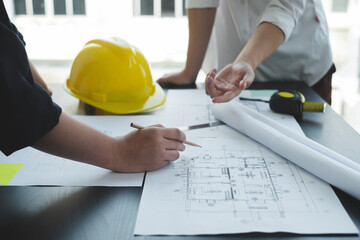 Team of engineers and architects, working team, meeting, discussing construction and drawing construction plans, printing, writing on-site construction sites. Home design concept