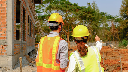 Engineer contractor team meeting work safety plan industry project and check design at the construction building site