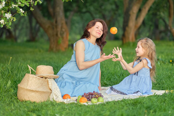mother and child having fun in the park. Mother and little daughter playing together in a park. Happy family concept.