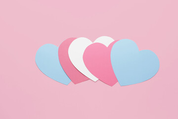 Paper hearts on color background. Concept of transgender