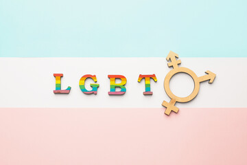 Symbol of transgender and abbreviation LGBT on color background