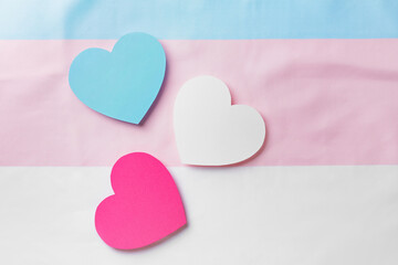 Paper hearts on flag of transgender