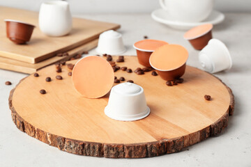 Board with coffee capsules on table