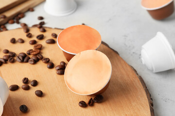 Board with coffee capsules on table