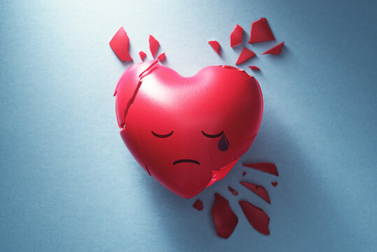 Broken heart on blue background. Sad expression in tears. Lost love and mental disorder image.