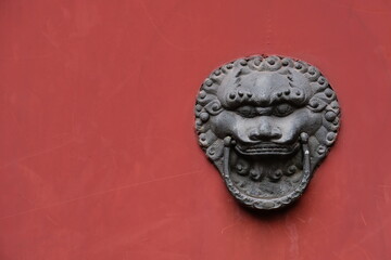 totem on the Traditional Chinese Door ,old red door color, door knocker in Chinese style