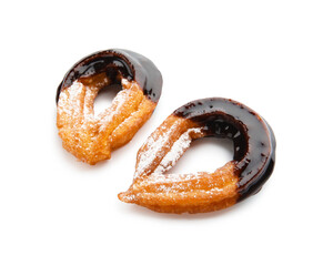 Tasty churros dipped in chocolate on white background
