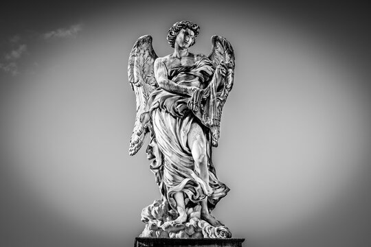 Medieval outdoor stone statue of an Angel with whips by Lazzaro Morelli on Sant'Angelo Bridge in Rome, Lazio region, Italy