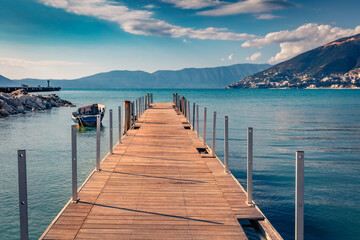 Wooden pier in Vlore port. Calm spring seascape of Adriatic sea. Wonderful outdoor scene of Albania, Europe. Traveling concept background.