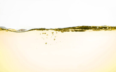 Yellow cooking oil splash with bubbles of air, isolated on the white background.