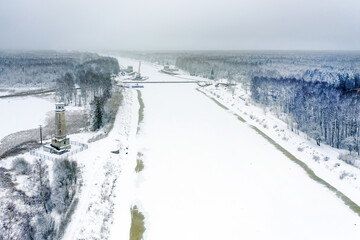 Fototapeta na wymiar A view from a height on a winter day at Big Volzhsky lighthouse on the river. Dubna city, Moscow region, Russia.