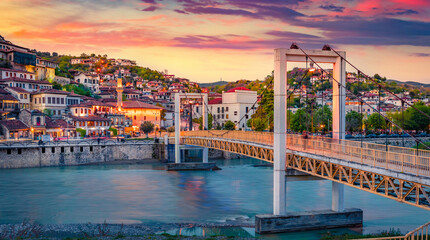 Amazing evening cityscape of Berat town. Splenedid spring sunset in Albania. Traveling concept...