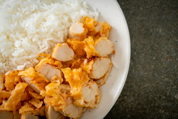 fried chicken topped rice with dipping sauce