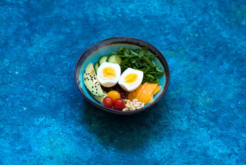 Bowl Healhty salad with avocado, egg and fresh vegetables. Сlean eating, top view. Healthy food concept.