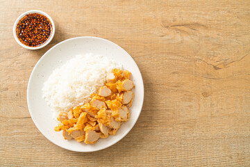 fried chicken topped rice with dipping sauce