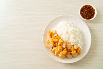 fried chicken topped rice with dipping sauce
