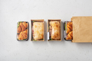 Sandwich in takeaway or delivery food box and paper bag