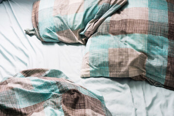 Undone bed sheet background. Empty bed background. Crumpled bedroom cloth. Morning messy bed.